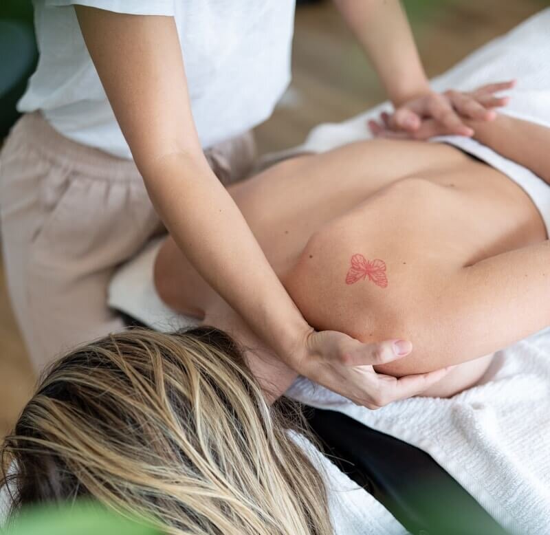 a woman getting a back massage in a spa