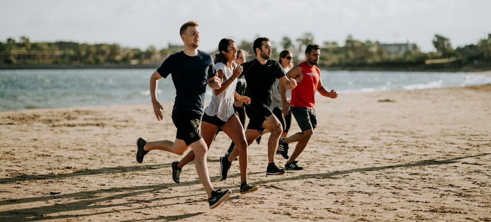 Photo by Unsplash men and women running on sea shore